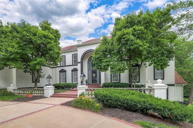 3109 W 118th St, Leawood, KS 66211 - mediterranean / spanish-style house with stucco siding and a tiled roof