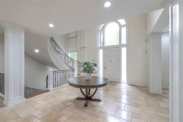 3109 W 118th St, Leawood, KS 66211 - foyer with decorative columns, recessed lighting, a high ceiling, stairs, and stone tile floors