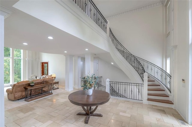 3109 W 118th St, Leawood, KS 66211 - entrance foyer featuring plenty of natural light, recessed lighting, stone finish floors, a high ceiling, and decorative columns