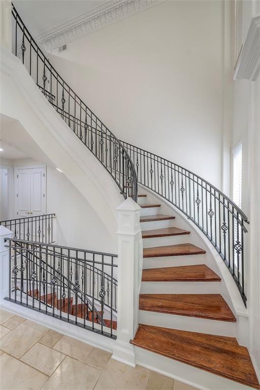 3109 W 118th St, Leawood, KS 66211 - staircase with a towering ceiling and tile patterned flooring