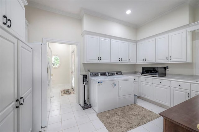 3109 W 118th St, Leawood, KS 66211 - laundry area featuring washer and dryer, light tile patterned floors, cabinet space, ornamental molding, and recessed lighting