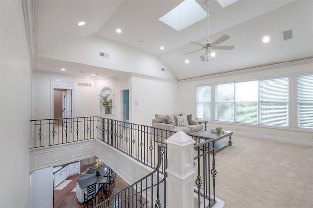 3109 W 118th St, Leawood, KS 66211 - carpeted living room featuring vaulted ceiling, recessed lighting, ceiling fan, and a skylight