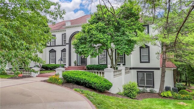 3109 W 118th St, Leawood, KS 66211 - mediterranean / spanish-style house featuring stucco siding and a tiled roof