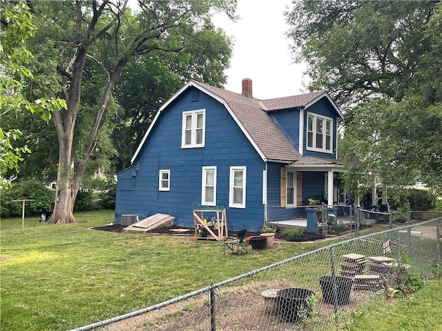 2302 3rd Ave, Leavenworth, KS 66048 - rear view of property featuring a chimney, a shingled roof, and central air condition unit