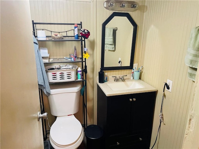 2302 3rd Ave, Leavenworth, KS 66048 - bathroom featuring vanity, toilet, and wood walls