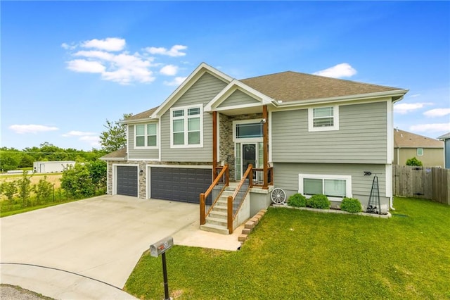 2808 E Cedar Pl, Tonganoxie, KS 66086 - raised ranch featuring concrete driveway and an attached garage