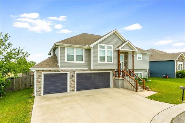 2808 E Cedar Pl, Tonganoxie, KS 66086 - raised ranch featuring an attached garage, concrete driveway, a shingled roof, and stone siding