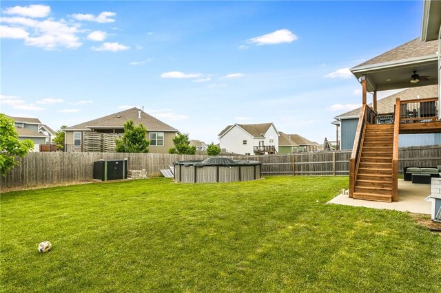2808 E Cedar Pl, Tonganoxie, KS 66086 - view of yard featuring stairs, ceiling fan, a residential view, and cooling unit