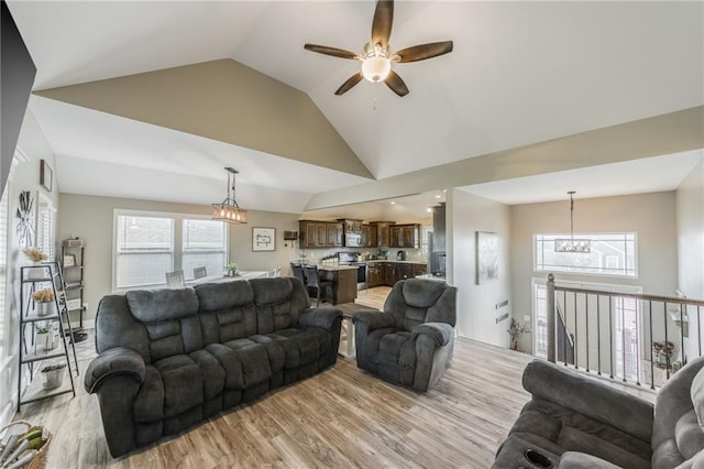 2808 E Cedar Pl, Tonganoxie, KS 66086 - living area featuring a ceiling fan, a chandelier, light wood-type flooring, healthy amount of natural light, and high vaulted ceiling