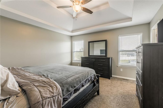 2808 E Cedar Pl, Tonganoxie, KS 66086 - bedroom featuring a tray ceiling, light carpet, baseboards, and a ceiling fan