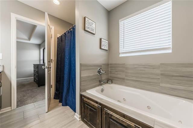 2808 E Cedar Pl, Tonganoxie, KS 66086 - bathroom featuring a whirlpool tub, vanity, and a shower with curtain
