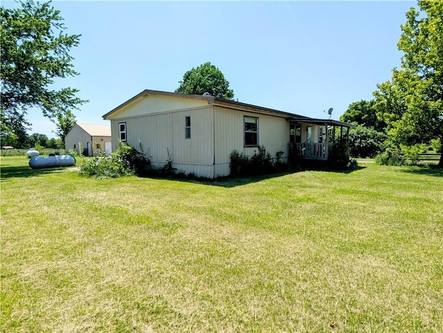 view of home's exterior with a lawn