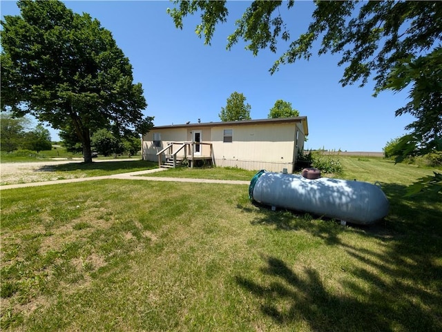 view of side of home with a lawn