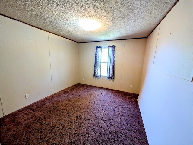 carpeted spare room featuring a textured ceiling