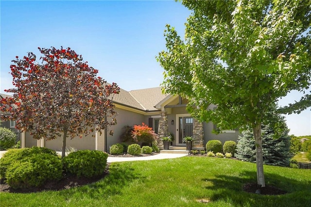 16812 Gillette St, Overland Park, KS 66221 - view of property hidden behind natural elements with a front yard, stucco siding, a garage, and stone siding