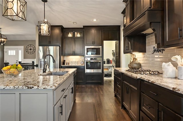16812 Gillette St, Overland Park, KS 66221 - kitchen featuring stainless steel appliances, a sink, light stone countertops, glass insert cabinets, and dark brown cabinetry