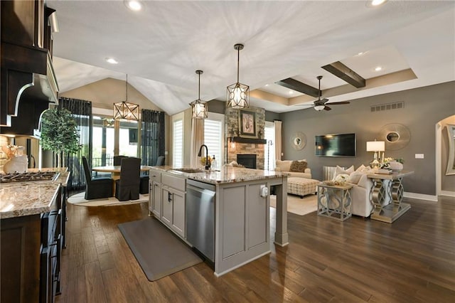 16812 Gillette St, Overland Park, KS 66221 - kitchen featuring dishwasher, a stone fireplace, ceiling fan, dark wood-style flooring, and a sink