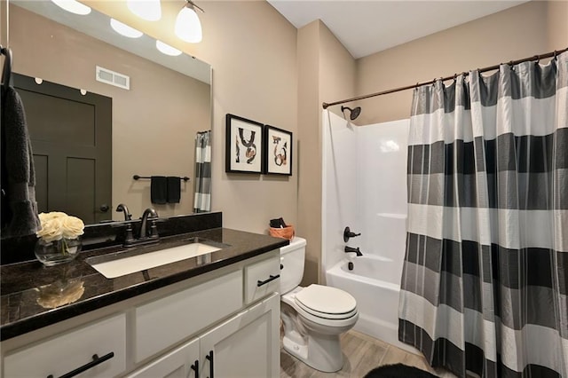16812 Gillette St, Overland Park, KS 66221 - bathroom with toilet, vanity, wood finished floors, and shower / bathtub combination with curtain