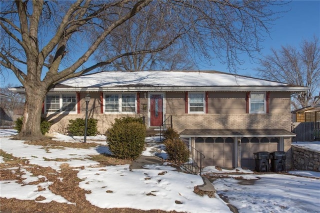 15402 E 37th Ter, Independence, MO 64055 - view of front facade with a garage, brick siding, and fence