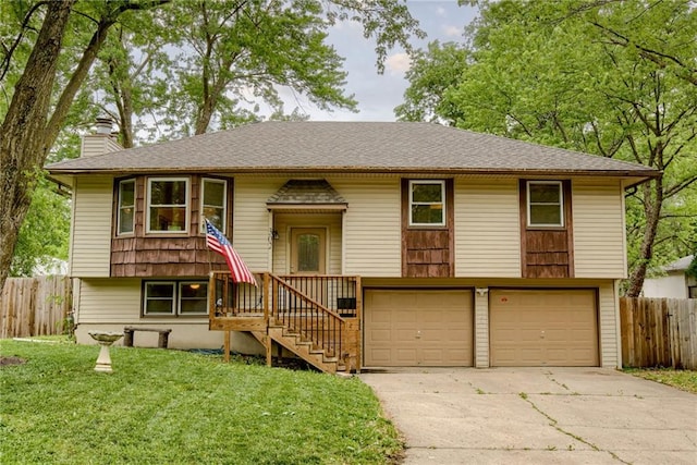 302 E 11th St, Kearney, MO 64060 - bi-level home with an attached garage, concrete driveway, and a chimney