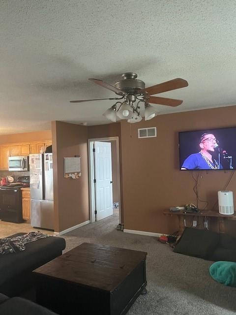 2216 Chanticleer St, Excelsior Springs, MO 64024 - living room with ceiling fan, a textured ceiling, baseboards, and light colored carpet