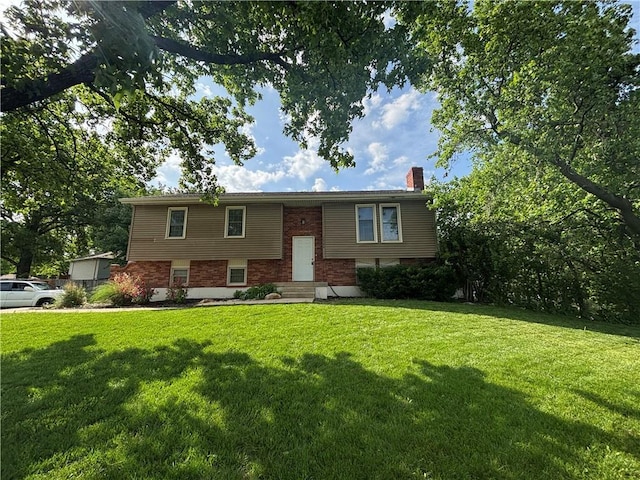 1724 SE 5th Ter, Lees Summit, MO 64063 - split foyer home with a chimney, a front lawn, and brick siding