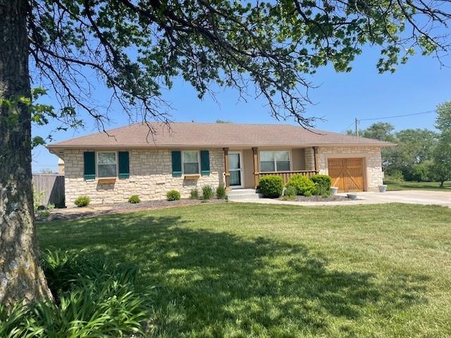 21162 147th St, Basehor, KS 66007 - ranch-style house with stone siding, an attached garage, and driveway
