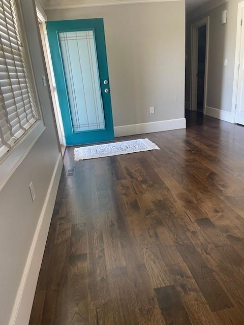 21162 147th St, Basehor, KS 66007 - foyer entrance featuring crown molding, baseboards, and dark wood finished floors