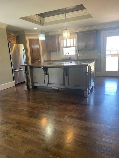 21162 147th St, Basehor, KS 66007 - kitchen with freestanding refrigerator, ornamental molding, a raised ceiling, baseboards, and dark wood-style floors