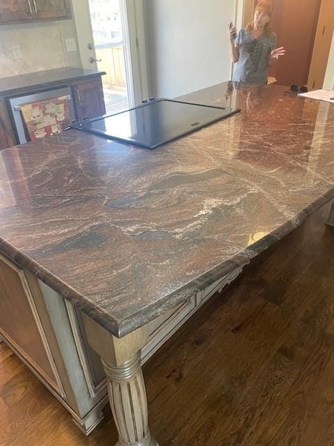 21162 147th St, Basehor, KS 66007 - detailed view of wood finished floors and black electric stovetop