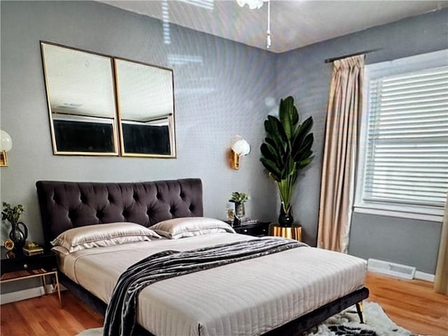 6404 N Harrison St, Oakview, MO 64118 - bedroom with wood finished floors and baseboards