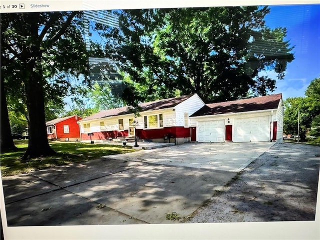 6404 N Harrison St, Oakview, MO 64118 - ranch-style house featuring concrete driveway and a garage