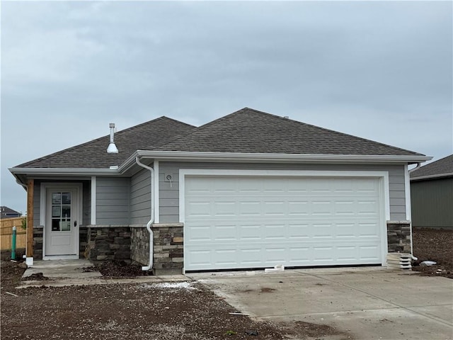 7920 SE 5th St, Blue Springs, MO 64014 - view of front facade with stone siding, concrete driveway, roof with shingles, and a garage