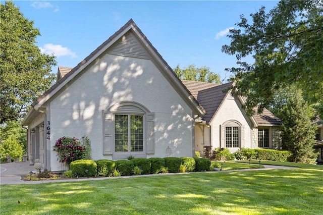3644 W 127th Ter, Leawood, KS 66209 - view of front of home featuring a front yard, an attached garage, stucco siding, and driveway