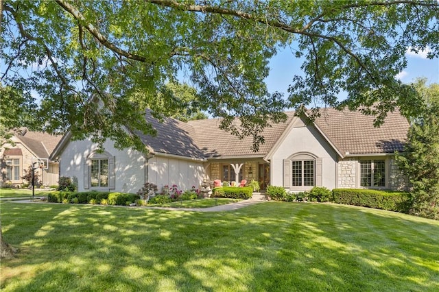 3644 W 127th Ter, Leawood, KS 66209 - view of front facade featuring a front yard, stone siding, stucco siding, and a tiled roof