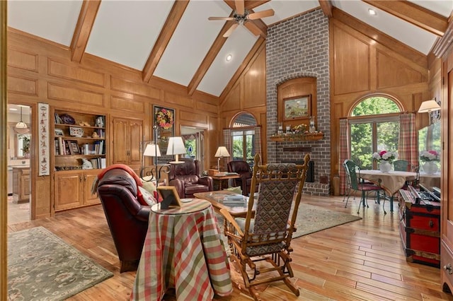 3644 W 127th Ter, Leawood, KS 66209 - living area with beam ceiling, high vaulted ceiling, light wood-type flooring, ceiling fan, and wooden walls