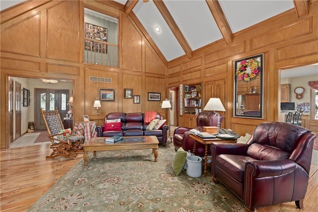 3644 W 127th Ter, Leawood, KS 66209 - living area featuring light wood finished floors, high vaulted ceiling, beamed ceiling, and a decorative wall