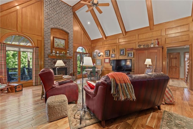 3644 W 127th Ter, Leawood, KS 66209 - living area with a brick fireplace, beam ceiling, light wood finished floors, a ceiling fan, and a decorative wall
