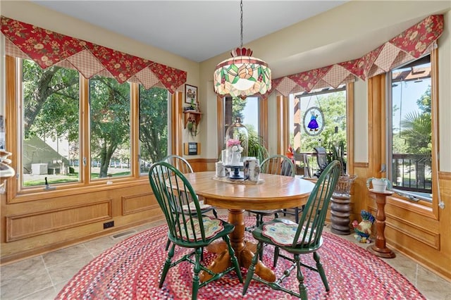 3644 W 127th Ter, Leawood, KS 66209 - dining space featuring plenty of natural light, light tile patterned flooring, and a wainscoted wall