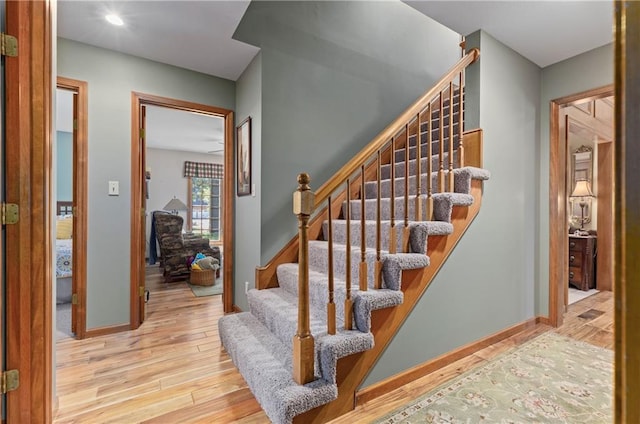 3644 W 127th Ter, Leawood, KS 66209 - stairs with wood finished floors, baseboards, and recessed lighting