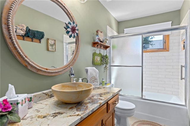 3644 W 127th Ter, Leawood, KS 66209 - bathroom featuring vanity, bath / shower combo with glass door, and toilet