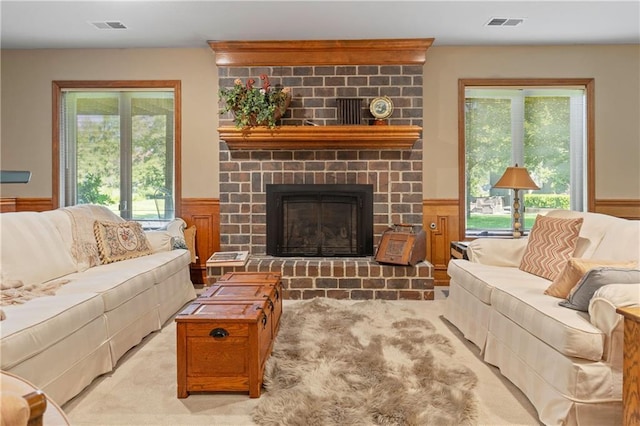 3644 W 127th Ter, Leawood, KS 66209 - living area with wainscoting, healthy amount of natural light, carpet flooring, and a brick fireplace