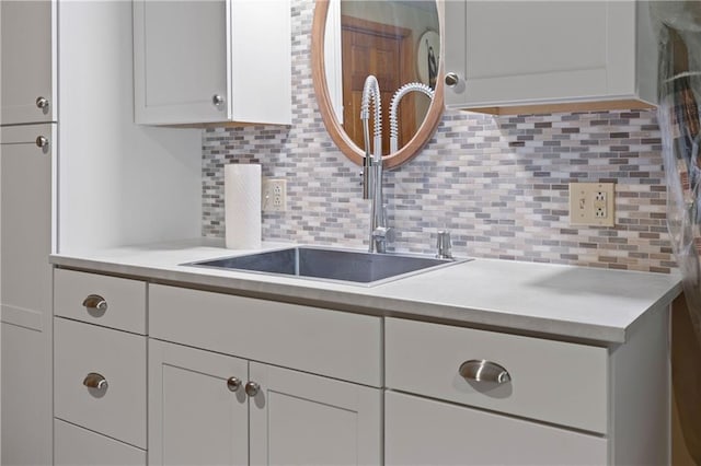 3644 W 127th Ter, Leawood, KS 66209 - kitchen with light countertops, a sink, backsplash, and white cabinets