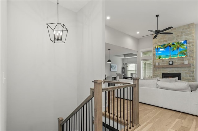 807 NE Algonquin St Unit B, Lees Summit, MO 64064 - hallway with an upstairs landing, light wood-style floors, a chandelier, a towering ceiling, and recessed lighting
