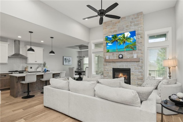 807 NE Algonquin St Unit B, Lees Summit, MO 64064 - living room with light wood-style flooring, ceiling fan, a fireplace, and recessed lighting