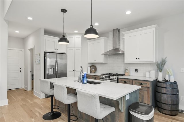 807 NE Algonquin St Unit B, Lees Summit, MO 64064 - kitchen with wall chimney range hood, a sink, light wood-type flooring, a breakfast bar area, and decorative backsplash