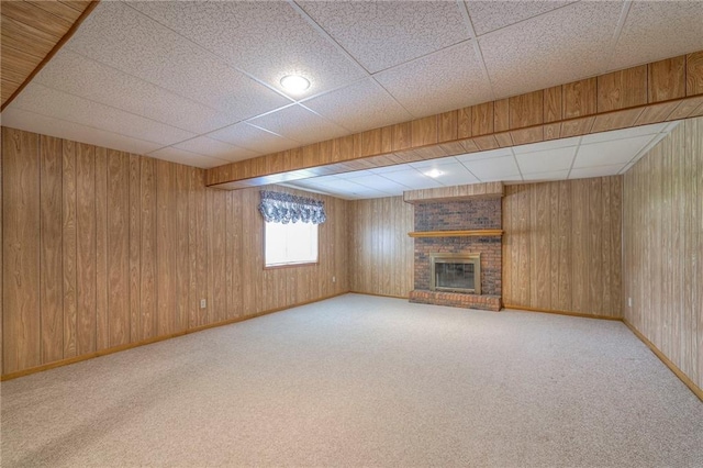 25908 Colbern Rd, Lees Summit, MO 64086 - unfurnished living room with a fireplace, carpet floors, a drop ceiling, baseboards, and wood walls