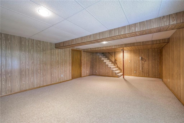 25908 Colbern Rd, Lees Summit, MO 64086 - finished below grade area with stairway, wood walls, carpet, a drop ceiling, and baseboards