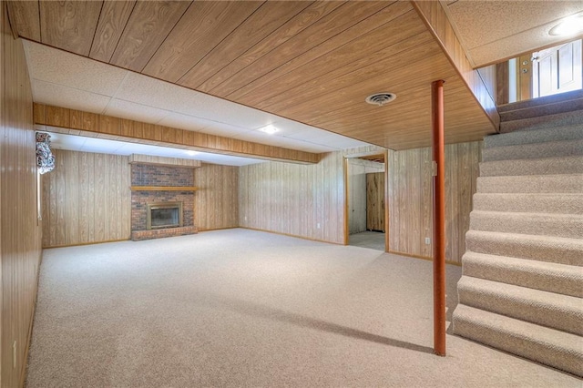25908 Colbern Rd, Lees Summit, MO 64086 - finished basement featuring stairs, carpet flooring, a brick fireplace, and wooden walls
