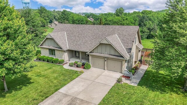 25908 Colbern Rd, Lees Summit, MO 64086 - view of front of property featuring board and batten siding, stone siding, roof with shingles, and an attached garage